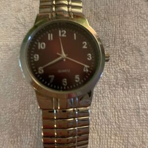 Men’s Fashion watch with brown face. Stretch silver band.
